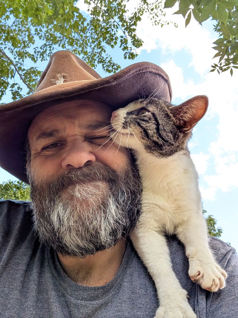 Chad Kovac with one of the farm cats on his shoulder